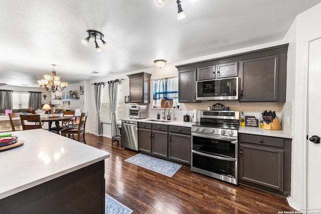 1623 Rainy Brk, Schertz, TX 78154 - kitchen featuring stainless steel appliances, a sink, a chandelier, and light countertops