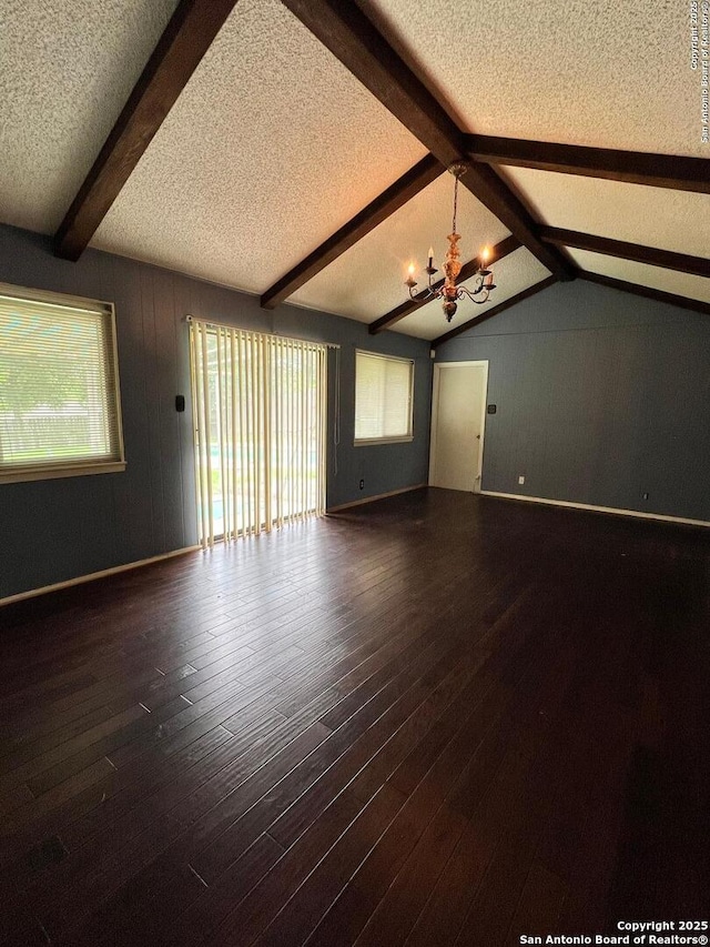6014 White Cloud, San Antonio, TX 78238 - unfurnished living room featuring a textured ceiling, a chandelier, wood finished floors, and wood walls