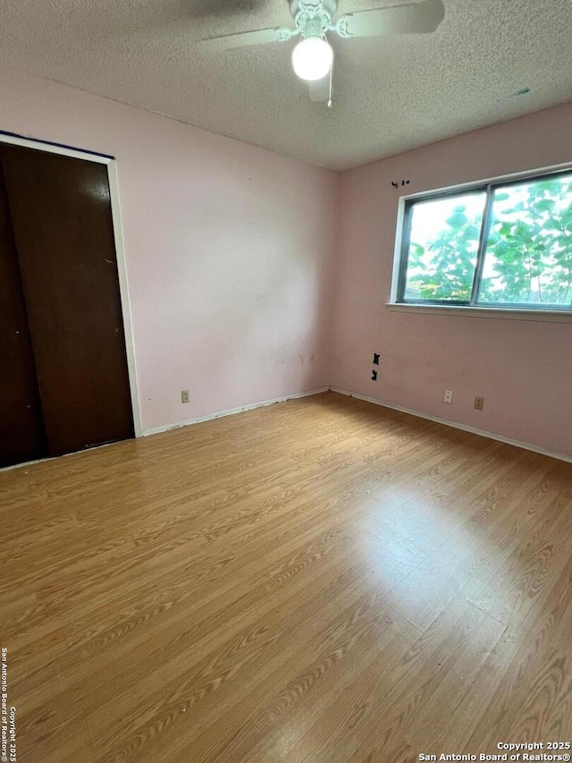 6014 White Cloud, San Antonio, TX 78238 - unfurnished bedroom with wood finished floors, a textured ceiling, baseboards, and ceiling fan