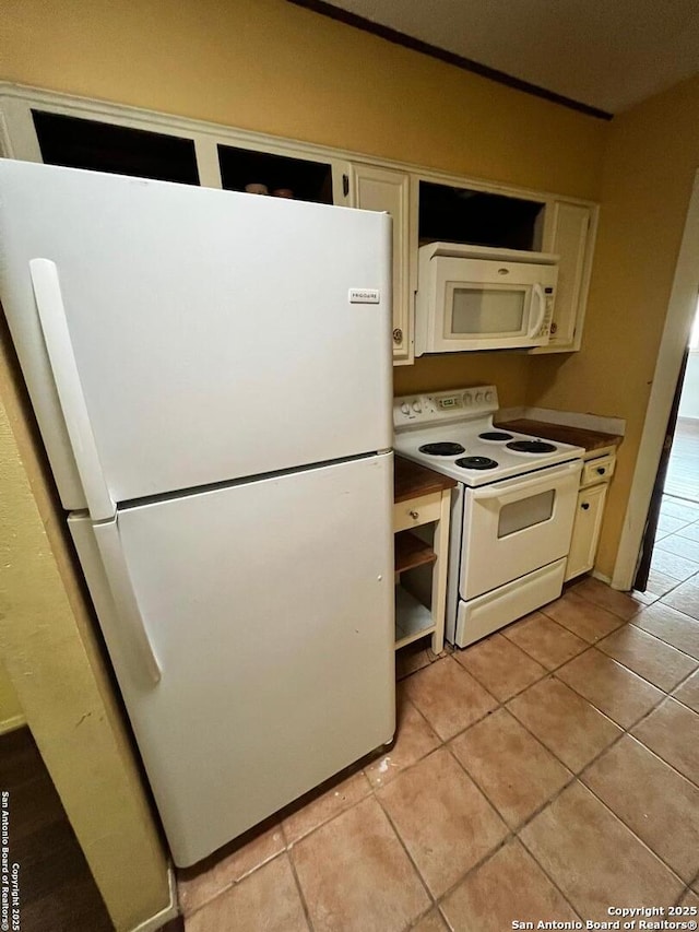 6014 White Cloud, San Antonio, TX 78238 - kitchen with white appliances, light tile patterned floors, white cabinetry, and dark countertops