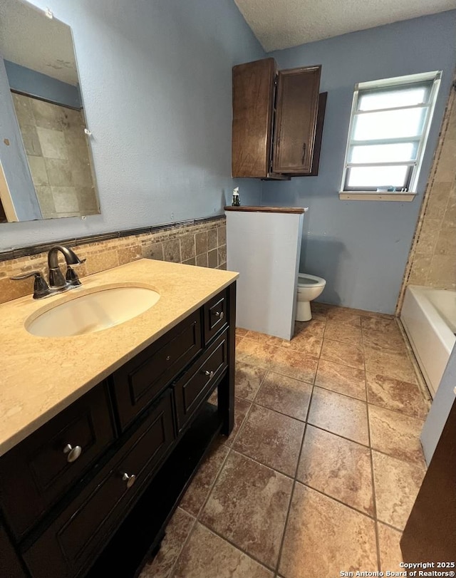 6014 White Cloud, San Antonio, TX 78238 - bathroom featuring toilet, vanity, and a textured ceiling