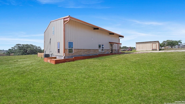 201 Lakeview Cir, La Vernia, TX 78121 - view of property exterior featuring a yard and central AC