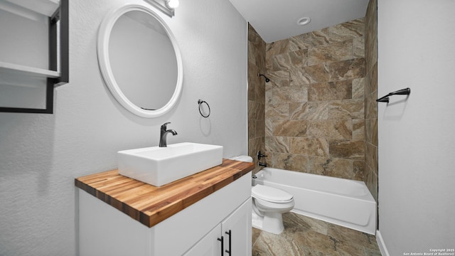 201 Lakeview Cir, La Vernia, TX 78121 - full bathroom featuring vanity, toilet, stone finish floors, shower / tub combination, and baseboards