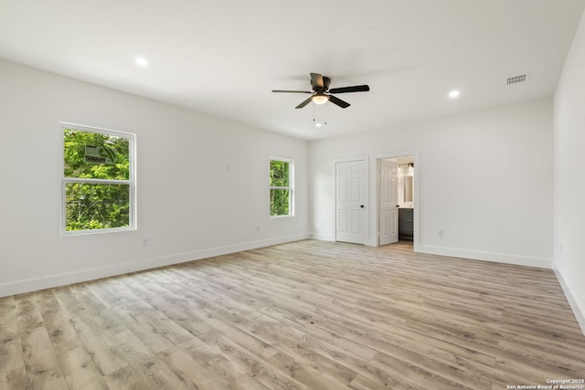 259 Future, San Antonio, TX 78213 - unfurnished bedroom with multiple windows, light wood-style floors, baseboards, recessed lighting, and ensuite bathroom