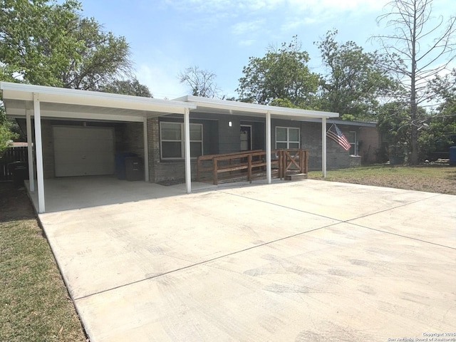 527 Artemis, San Antonio, TX 78218 - view of front of property featuring driveway, a porch, an attached garage, brick siding, and an attached carport