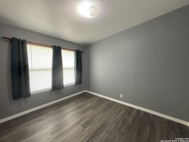 527 Artemis, San Antonio, TX 78218 - unfurnished room with dark wood finished floors, baseboards, and a textured ceiling