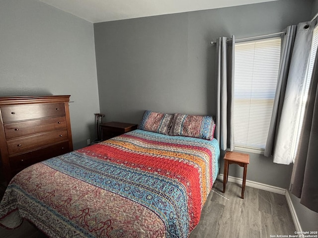 527 Artemis, San Antonio, TX 78218 - bedroom featuring wood finished floors, baseboards, and multiple windows