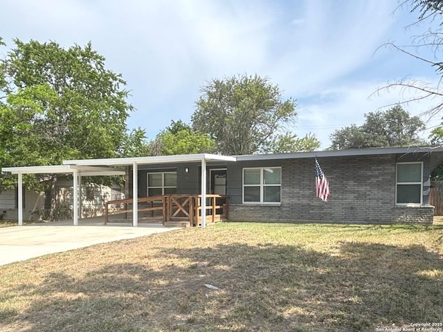 527 Artemis, San Antonio, TX 78218 - view of front of home featuring a front lawn, concrete driveway, an attached carport, and brick siding