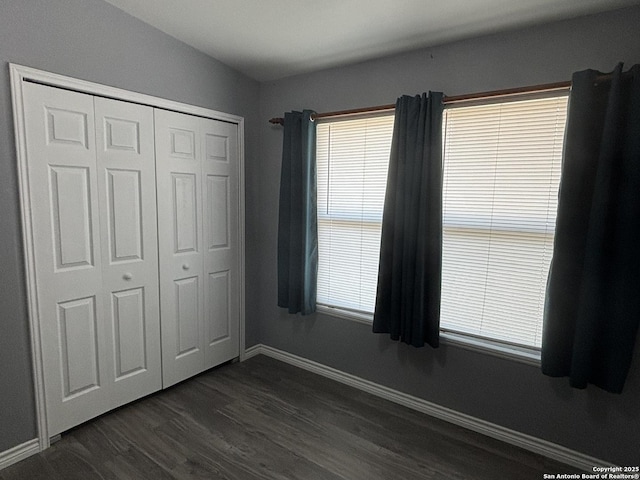 527 Artemis, San Antonio, TX 78218 - unfurnished bedroom with dark wood finished floors, baseboards, and a closet