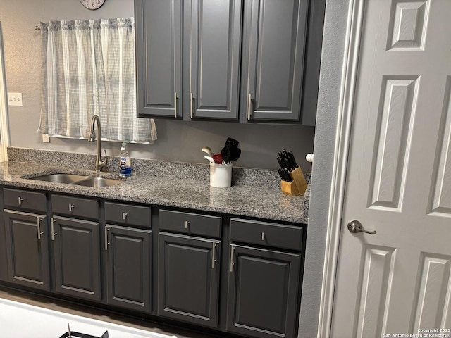 527 Artemis, San Antonio, TX 78218 - kitchen featuring a sink, gray cabinets, and dark stone countertops