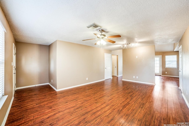 756 County Road 245, Hondo, TX 78861 - spare room featuring a ceiling fan, a textured ceiling, wood finished floors, and baseboards