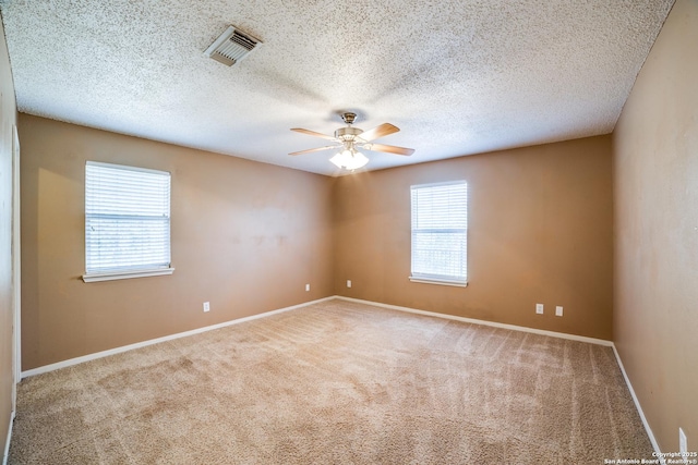 756 County Road 245, Hondo, TX 78861 - unfurnished room featuring carpet, ceiling fan, baseboards, and a textured ceiling