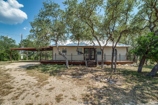 756 County Road 245, Hondo, TX 78861 - back of house featuring a wooden deck, driveway, and metal roof