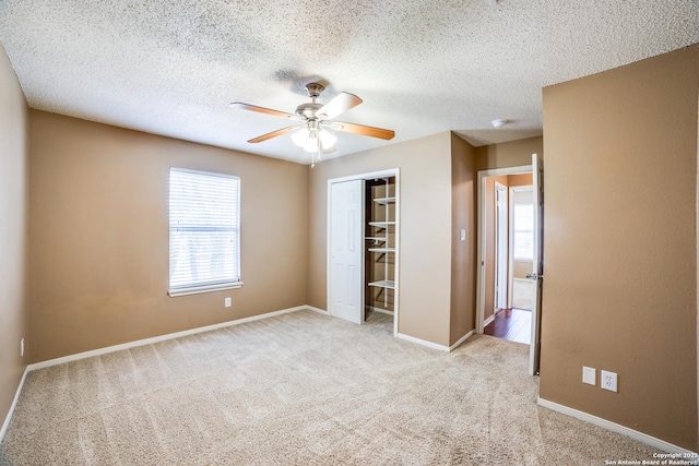 756 County Road 245, Hondo, TX 78861 - unfurnished bedroom with light colored carpet, a closet, baseboards, a ceiling fan, and a textured ceiling