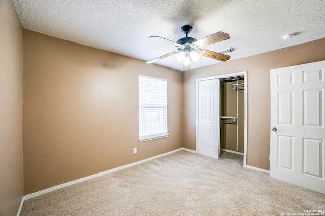 756 County Road 245, Hondo, TX 78861 - unfurnished bedroom featuring a closet, light carpet, a textured ceiling, baseboards, and ceiling fan