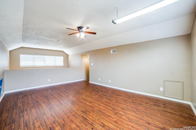 756 County Road 245, Hondo, TX 78861 - spare room featuring a textured ceiling, ceiling fan, lofted ceiling, wood finished floors, and baseboards