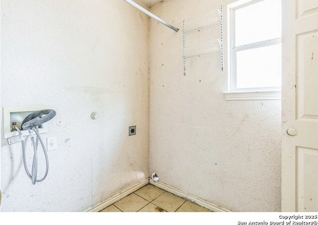 2514 Christian, San Antonio, TX 78222 - washroom featuring hookup for a washing machine, hookup for an electric dryer, and light tile patterned floors