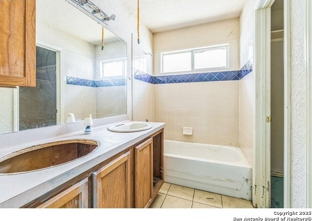 2514 Christian, San Antonio, TX 78222 - bathroom with double vanity, tile patterned floors, and washtub / shower combination