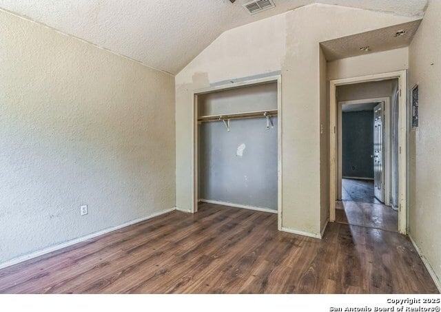 2514 Christian, San Antonio, TX 78222 - unfurnished bedroom featuring lofted ceiling, a textured wall, wood finished floors, a closet, and baseboards
