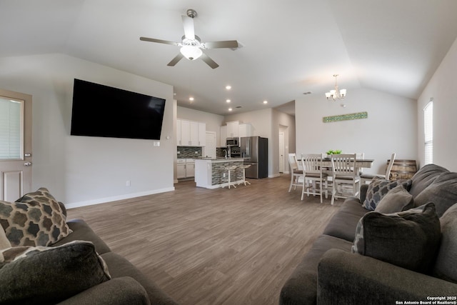 6955 Shiraz Way, Converse, TX 78109 - living area with vaulted ceiling, a chandelier, ceiling fan, wood finished floors, and baseboards