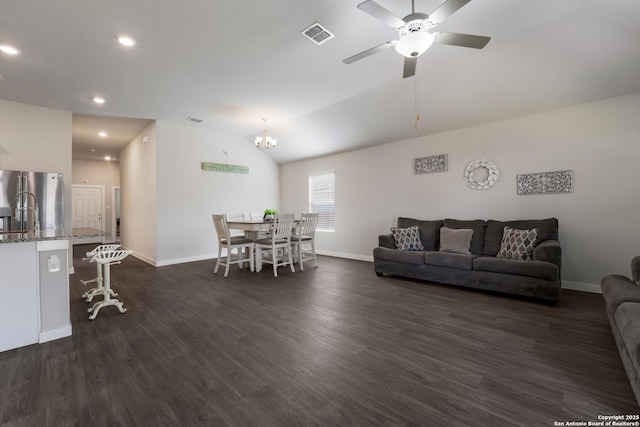 6955 Shiraz Way, Converse, TX 78109 - living area with baseboards, dark wood-style floors, a ceiling fan, vaulted ceiling, and a chandelier