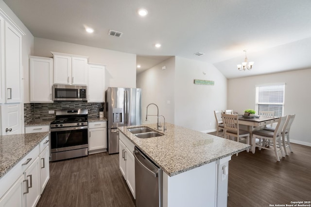 6955 Shiraz Way, Converse, TX 78109 - kitchen with appliances with stainless steel finishes, dark wood finished floors, a sink, white cabinetry, and a chandelier