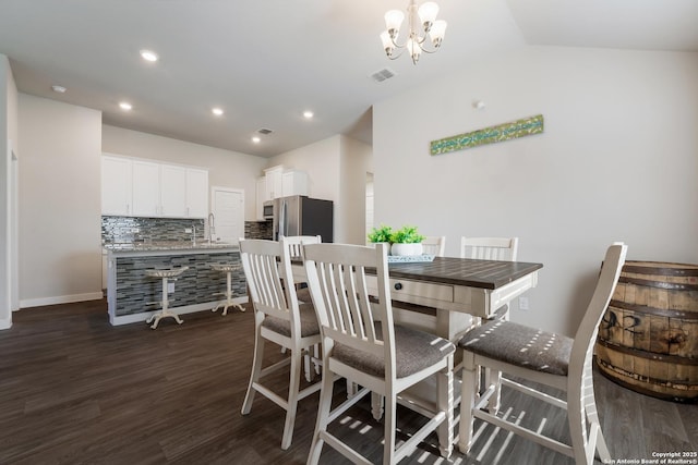 6955 Shiraz Way, Converse, TX 78109 - dining room with dark wood finished floors, a chandelier, recessed lighting, vaulted ceiling, and baseboards