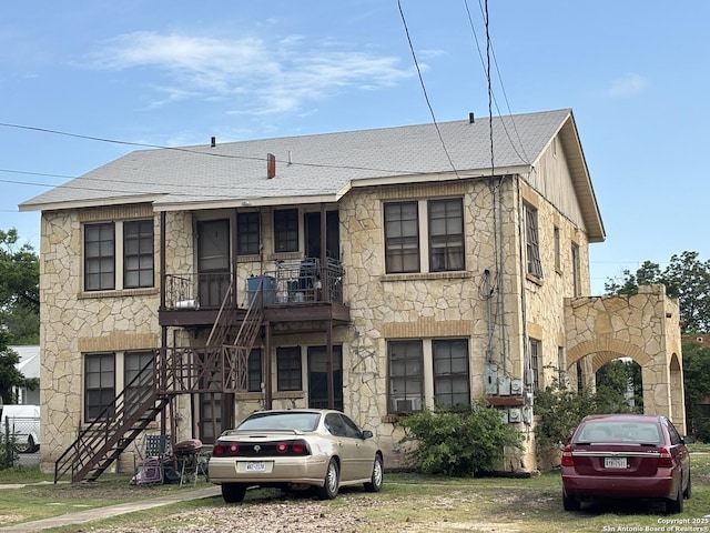 1502 W Woodlawn, San Antonio, TX 78201 - view of front of house featuring stone siding, stairs, cooling unit, and roof with shingles