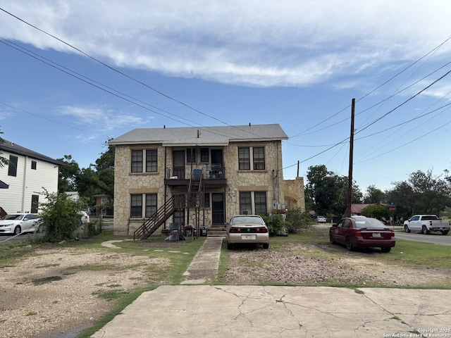 1502 W Woodlawn, San Antonio, TX 78201 - view of property featuring stone siding and a balcony