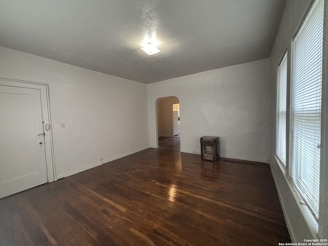 1502 W Woodlawn, San Antonio, TX 78201 - unfurnished room featuring arched walkways, wood finished floors, healthy amount of natural light, and baseboards