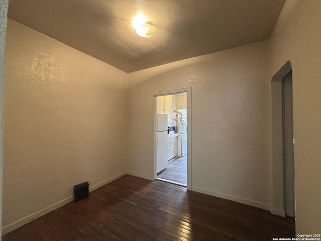 1502 W Woodlawn, San Antonio, TX 78201 - spare room featuring dark wood-type flooring, baseboards, and a textured wall