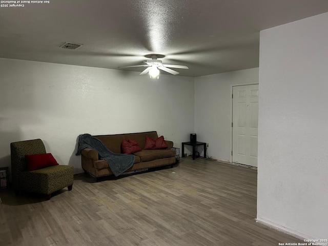 314 US Highway 57, La Pryor, TX 78872 - living room featuring a ceiling fan, wood finished floors, and baseboards