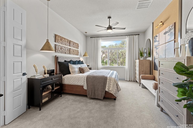 20675 Huebner Rd, San Antonio, TX 78258 - bedroom with light carpet, a textured ceiling, and a ceiling fan