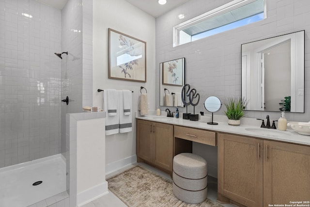 20675 Huebner Rd, San Antonio, TX 78258 - bathroom featuring double vanity, a walk in shower, baseboards, and tile patterned floors