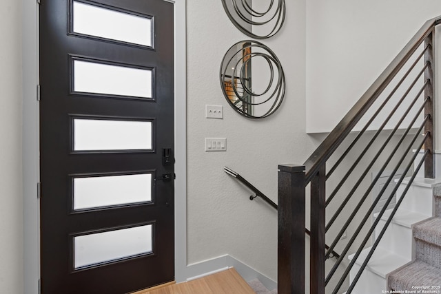 20675 Huebner Rd, San Antonio, TX 78258 - entryway featuring stairway, plenty of natural light, baseboards, and wood finished floors