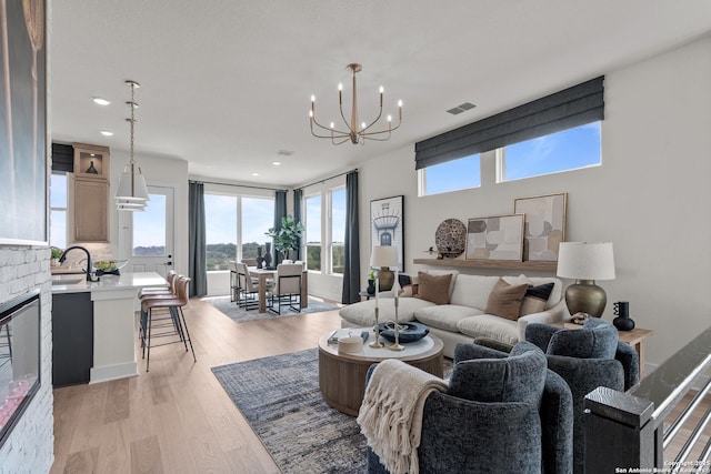 20675 Huebner Rd, San Antonio, TX 78258 - living room with recessed lighting, a chandelier, and light wood-style floors