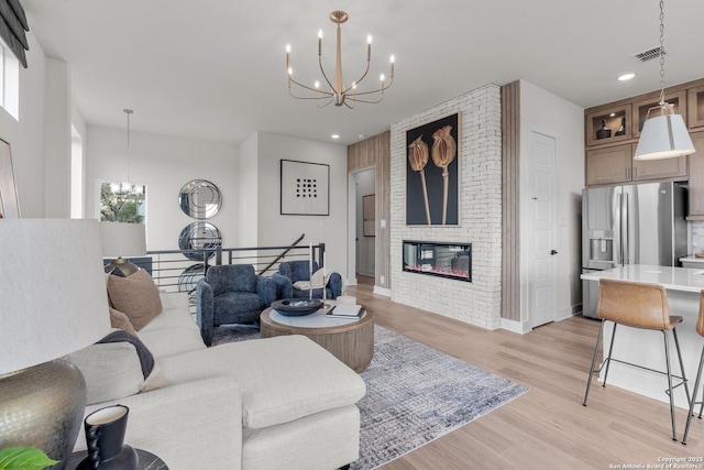 20675 Huebner Rd, San Antonio, TX 78258 - living room with a chandelier, light wood finished floors, a fireplace, recessed lighting, and baseboards