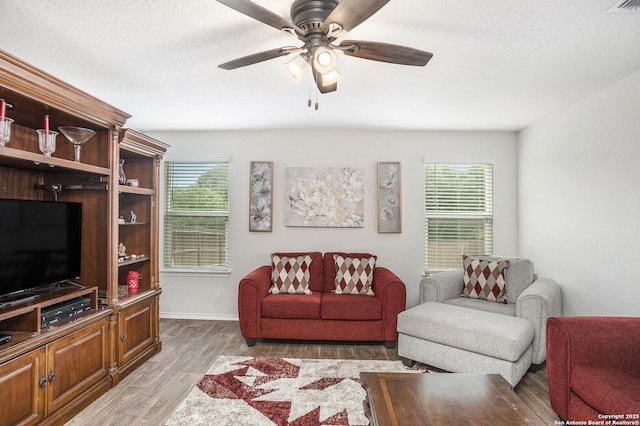 14506 Tundra Swan, San Antonio, TX 78253 - living area with light wood-type flooring, a ceiling fan, baseboards, and a textured ceiling