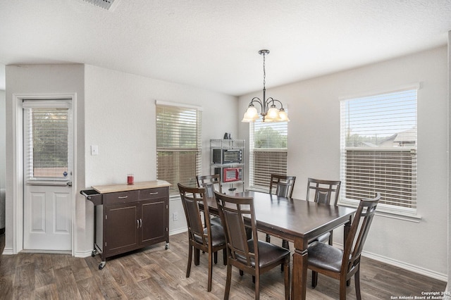 14506 Tundra Swan, San Antonio, TX 78253 - dining room featuring a chandelier, dark wood-style floors, and baseboards