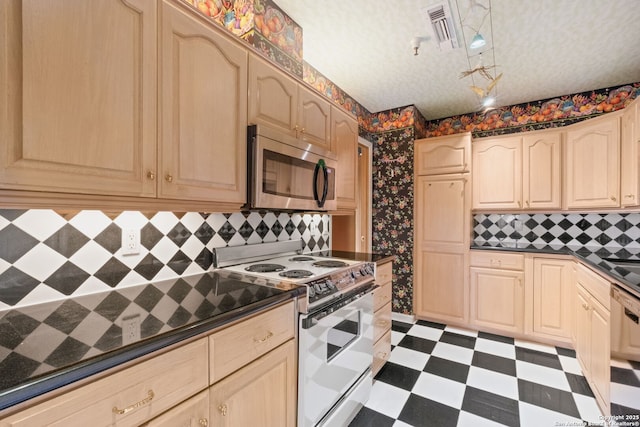 1 Towers Park Ln Unit 1512, San Antonio, TX 78209 - kitchen with stainless steel microwave, white range with electric cooktop, tile patterned floors, dark countertops, and dishwashing machine
