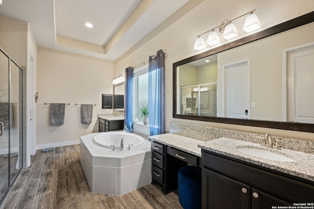 7938 Cibolo, Boerne, TX 78015 - full bath with a shower stall, two vanities, a garden tub, and wood finished floors