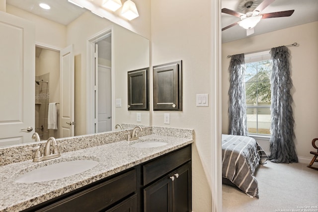 7938 Cibolo, Boerne, TX 78015 - bathroom with double vanity, ceiling fan, baseboards, and connected bathroom