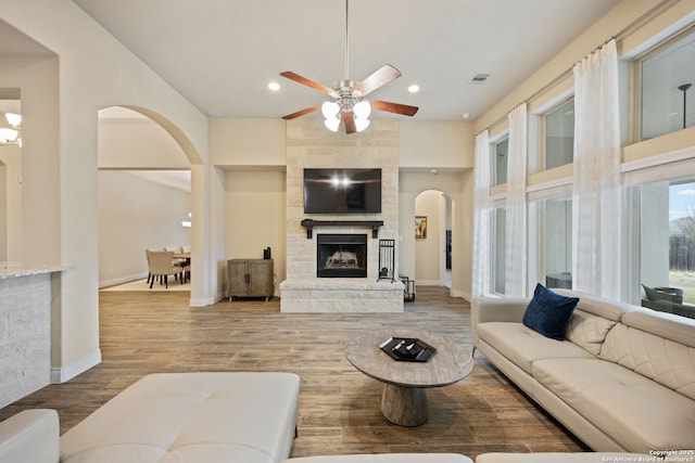 7938 Cibolo, Boerne, TX 78015 - living area with arched walkways, ceiling fan, a fireplace, recessed lighting, and wood finished floors