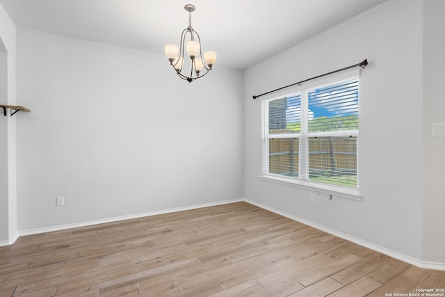 11423 Roadrunner, San Antonio, TX 78245 - unfurnished room featuring a chandelier, light wood-style floors, and baseboards