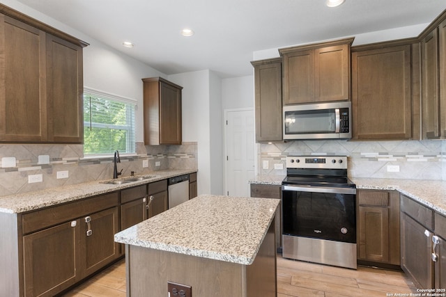 11423 Roadrunner, San Antonio, TX 78245 - kitchen with appliances with stainless steel finishes, a sink, light wood-style floors, light stone counters, and recessed lighting