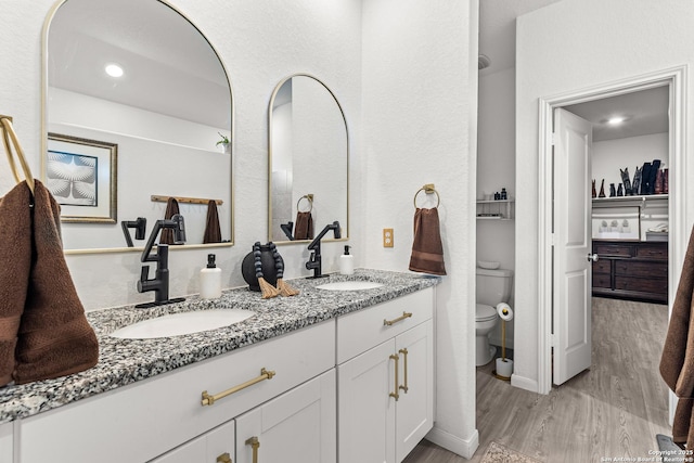 5481 Reverence, Bulverde, TX 78163 - bathroom with double vanity, wood finished floors, toilet, and recessed lighting