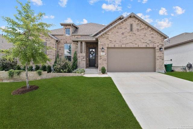 122 Indigo Bnd, Boerne, TX 78006 - view of front of house featuring brick siding, a front yard, a garage, driveway, and a shingled roof