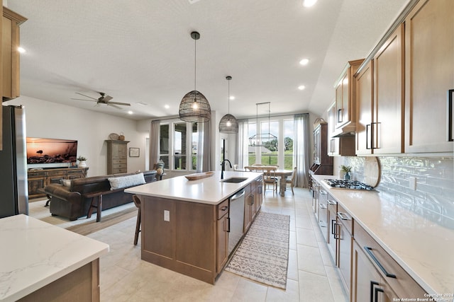 122 Indigo Bnd, Boerne, TX 78006 - kitchen featuring a sink, appliances with stainless steel finishes, open floor plan, a ceiling fan, and tasteful backsplash