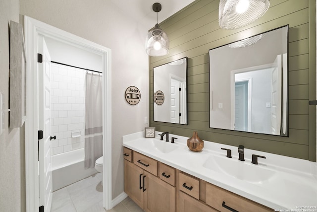 122 Indigo Bnd, Boerne, TX 78006 - bathroom with double vanity, toilet, tile patterned floors, shower / tub combo, and wooden walls