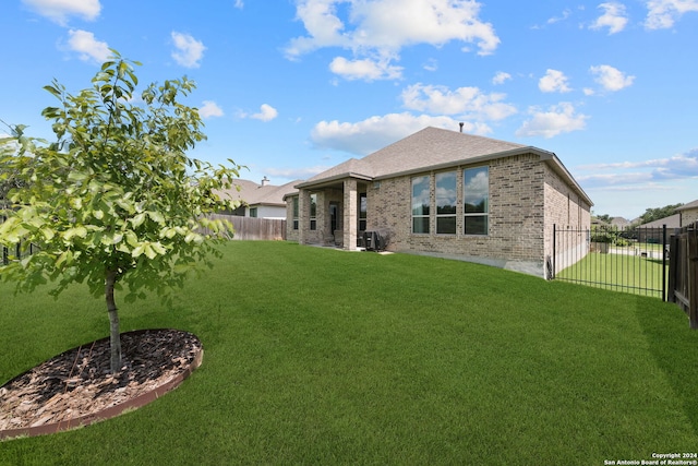 122 Indigo Bnd, Boerne, TX 78006 - back of house featuring brick siding and roof with shingles